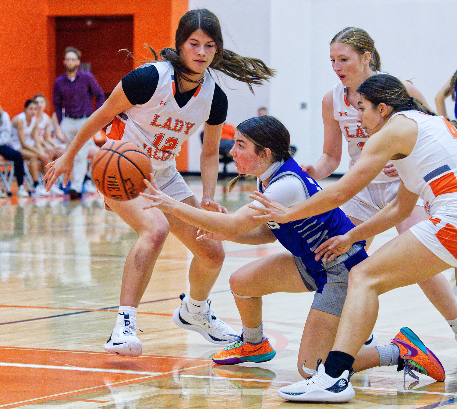 Left to right, Mahayla McMahon, Macy Fischer and Carmen Carrasco apply full-court pressure to Rains. [more hoops highlights here]